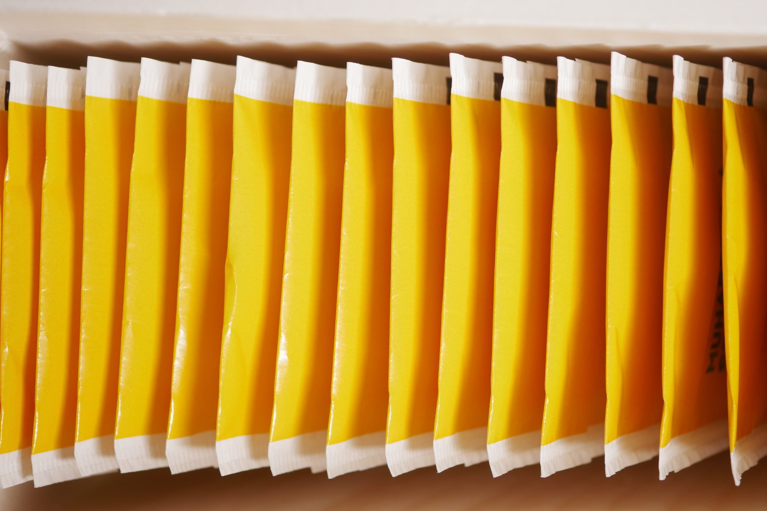 tea bags in yellow packet on table tea bags in yellow packet on table .